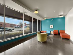 Minneapolis apartment for rent - The front lobby of West Broadway Crecent with a blue wall and a yellow chair.