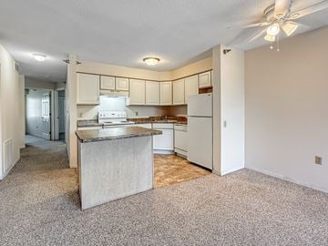 Plymouth townhouse for rent - A kitchen with a white refrigerator and a countertop.