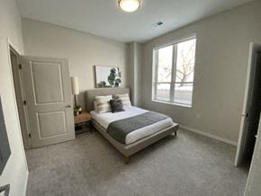 Minneapolis apartment for rent - A bedroom with a bed, nightstand, and window.