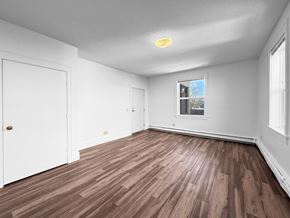 Minneapolis apartment for rent - A room with wooden flooring and white walls.