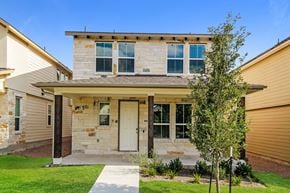 Dripping Springs townhouse for rent - a house with a white door and a tree in front of it