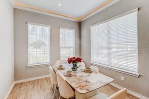 Waxahachie townhouse for rent - a dining room with a table and chairs and two windows