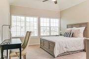 Denton townhouse for rent - A bedroom with a bed, chair, and desk.