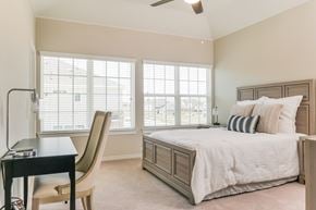 Denton townhouse for rent - A bedroom with a bed, chair, and desk.
