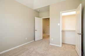 Rosharon townhouse for rent - an empty bedroom with an open door and a closet