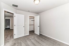 Dripping Springs townhouse for rent - a bedroom with two closets and a carpeted floor