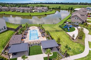 Montgomery townhouse for rent - A swimming pool surrounded by houses and a fence.