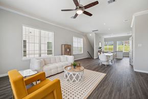 Montgomery townhouse for rent - A living room with a white couch, a yellow chair, and a coffee table.