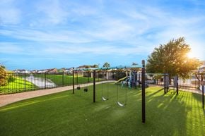 Houston townhouse for rent - A playground with a slide, swings, and a tee-ball set.