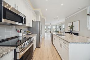 Houston townhouse for rent - A modern kitchen with range and microwave above it.