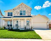 Denton townhouse for rent - A house with a stone facade and a white garage door.
