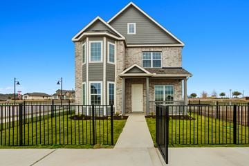 Kyle townhouse for rent - A house with a black fence in front of it.