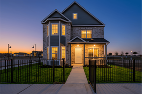 Kyle townhouse for rent - A house with a black fence and a walkway leading to the front door.