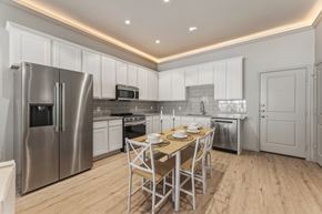 New Braunfels townhouse for rent - A modern kitchen with a dining table set for two.