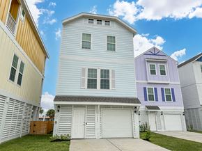Galveston townhouse for rent - a white house with a garage in front of other houses