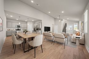 Kyle townhouse for rent - A modern dining room with a wooden table and chairs.