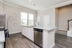 Galveston townhouse for rent - a kitchen with an island and a stainless steel dishwasher