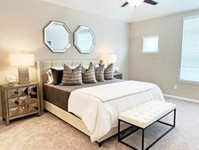 Houston townhouse for rent - a bedroom with a bed and two mirrors on the wall