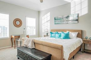 Montgomery townhouse for rent - A bedroom with a large bed and a painting on the wall.