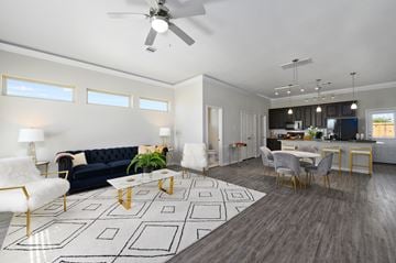 League City townhouse for rent - a living room with couches and chairs and a kitchen with a table and chairs