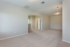 Rosharon townhouse for rent - an empty living room with carpet and a door to a hallway