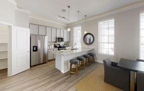 Houston townhouse for rent - a kitchen and living room with an island and a refrigerator