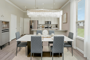 Katy townhouse for rent - A modern dining room with a large table and grey chairs.