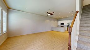 Red Oak townhouse for rent - A room with a staircase on the right side and a ceiling fan on the left.