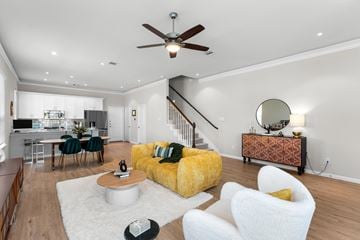 Atascocita townhouse for rent - A living room with a yellow sofa and a white coffee table.