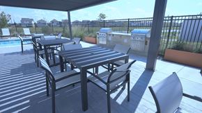 Rosharon townhouse for rent - A patio with a table and chairs overlooking a pool.