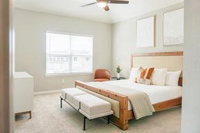 Katy townhouse for rent - a bedroom with a large bed and a ceiling fan at Enclave at Mason Creek, Katy,Texas