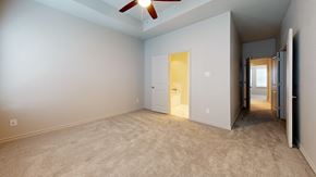 Red Oak townhouse for rent - A room with a ceiling fan and carpeted floor.