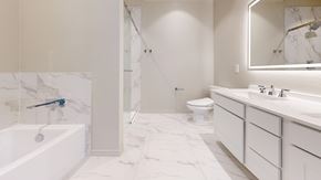 Red Oak townhouse for rent - A white bathroom with a marble floor and a glass shower stall.