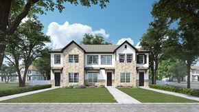 Crowley townhouse for rent - A large, two-story house with a stone facade and a gabled roof is surrounded by a well-manicured lawn and mature trees.