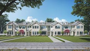 Crowley townhouse for rent - A large, well-maintained building with multiple windows and a green lawn in front.