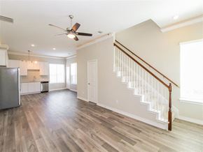 Denton apartment for rent - a living room with hardwood floors and a ceiling fan