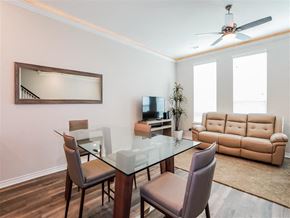 Denton apartment for rent - a living room with a glass table and chairs