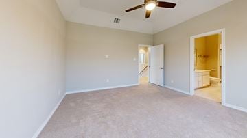 Waxahachie townhouse for rent - A room with a ceiling fan and carpeted floor.