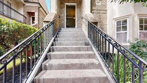 Kingwood townhouse for rent - A set of stairs with a metal railing lead to a doorway.