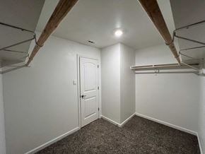 Youngsville house for rent - A room with a white door and a carpeted floor.