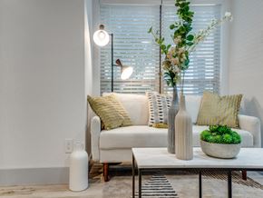 Dallas apartment for rent - a living room with a couch and a table with a vase