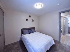 Groton apartment for rent - a white bedroom with a bed and a door to a bathroom