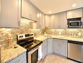 Groton apartment for rent - a kitchen with stainless steel appliances and white cabinets