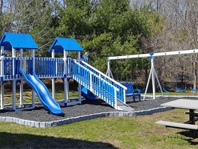 Norwich apartment for rent - a playground with a blue slide and swing set