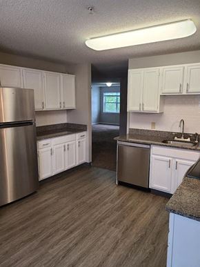 Norwich apartment for rent - a kitchen with white cabinets and stainless steel appliances