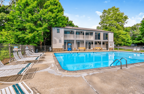 Groton apartment for rent - a swimming pool with chairs and a house in the background