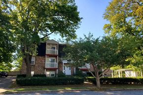 New London apartment for rent - a brick apartment building with trees in front of it