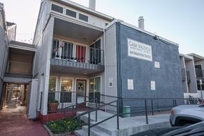 Dallas apartment for rent - the front of a building with stairs and a sign