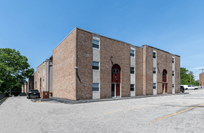 New London apartment for rent - a brick building with two doors and a parking lot