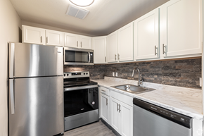 New London apartment for rent - a kitchen with stainless steel appliances and white cabinets